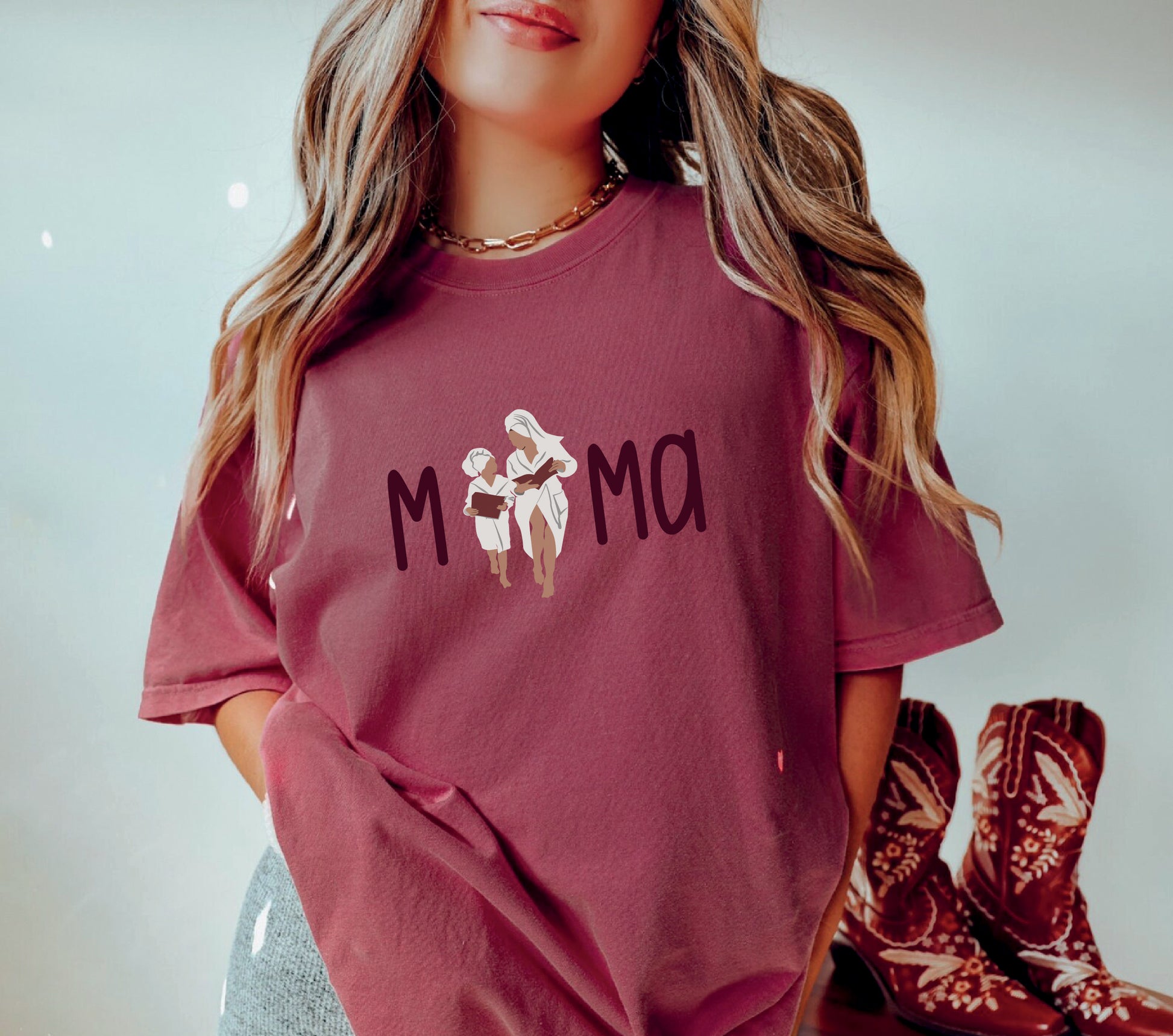 a woman wearing a maroon shirt with a flower on it