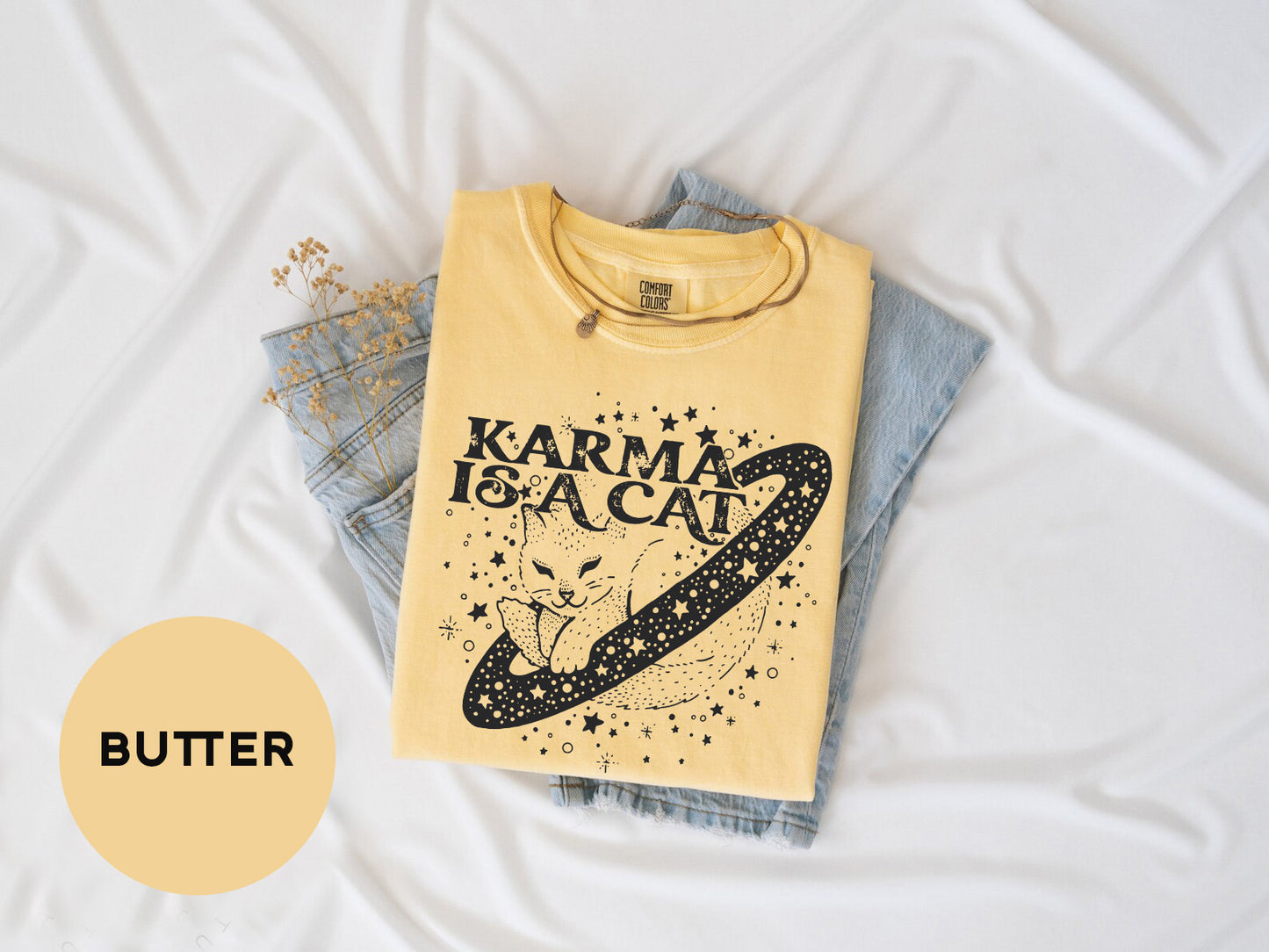 a yellow t - shirt with a picture of a cat on it