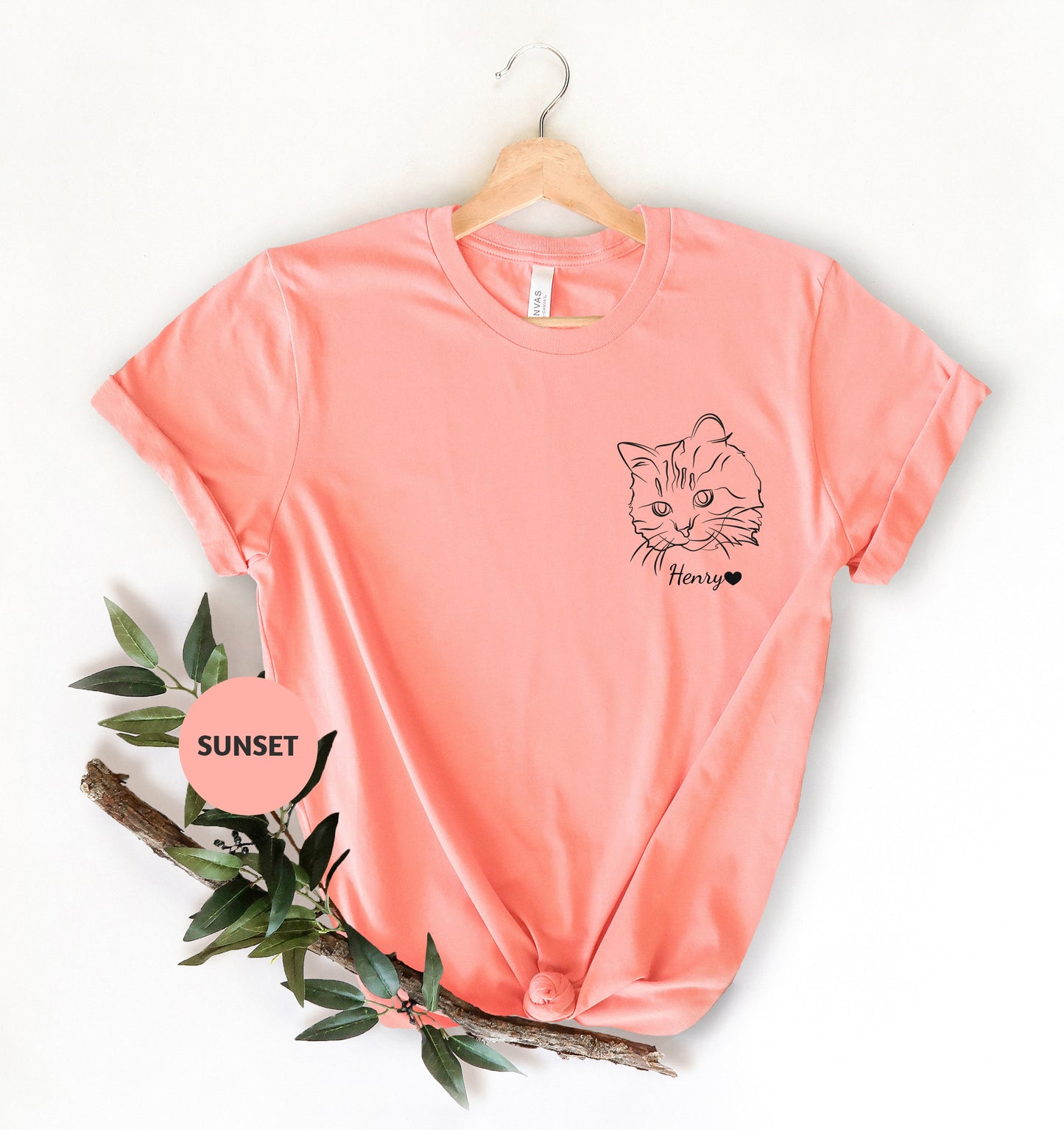 a pink t - shirt with a cat on it