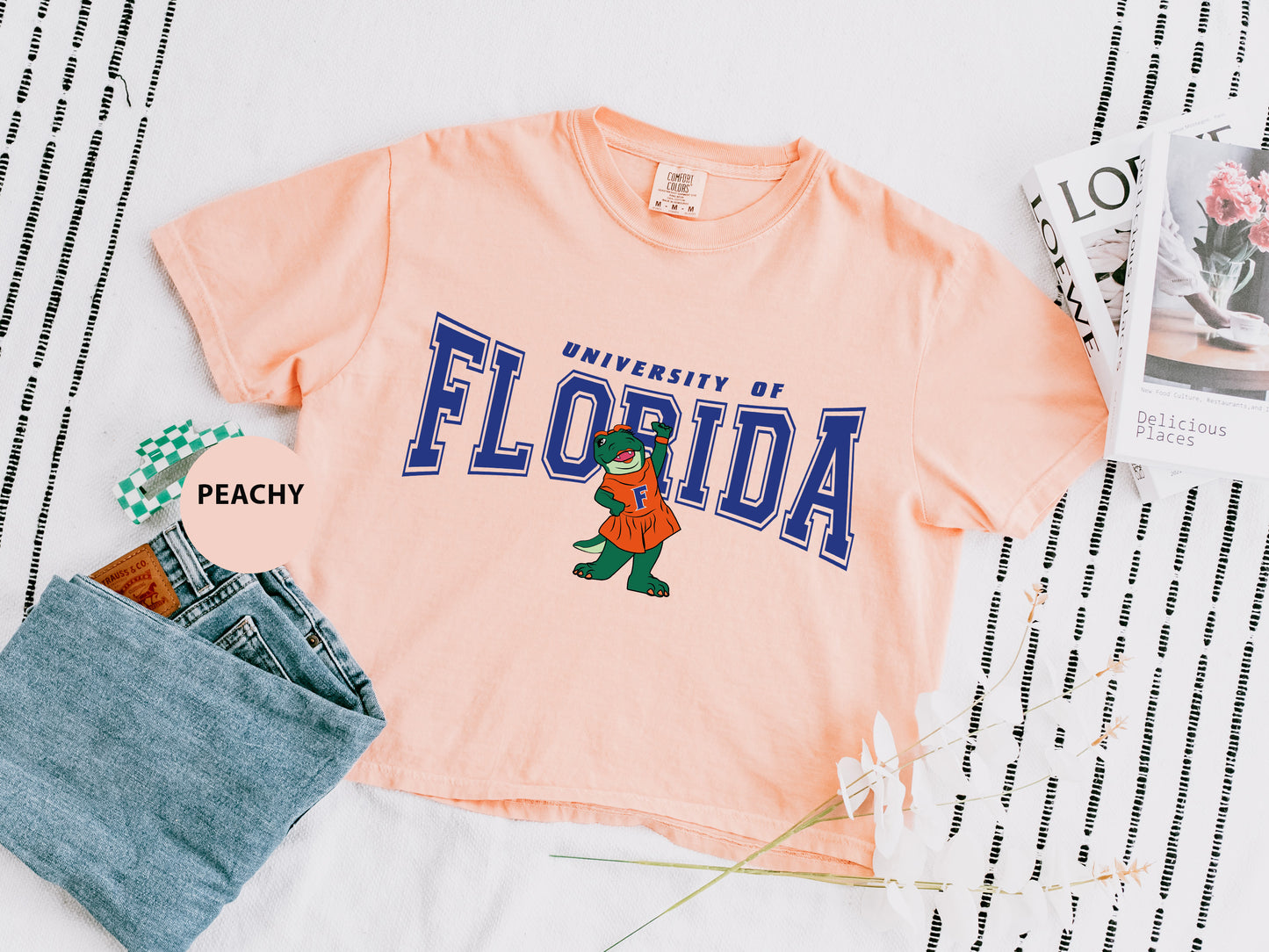 a t - shirt that says university of florida next to a pair of jeans