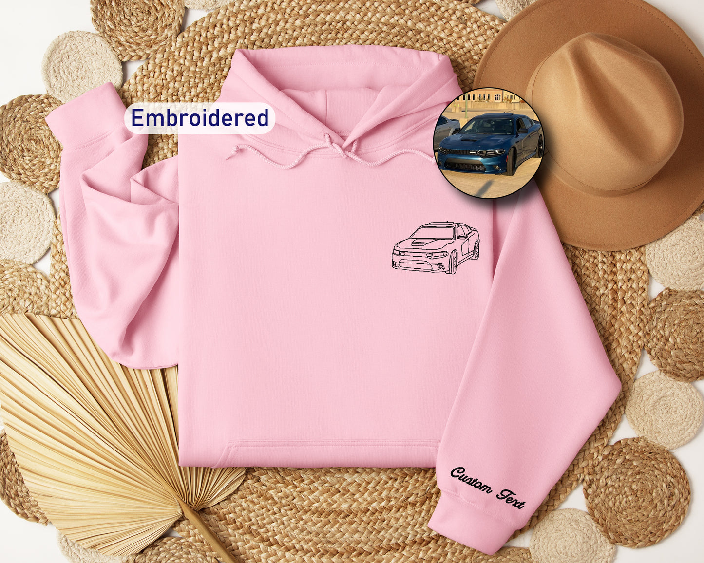 a pink hoodie with a picture of a car on it