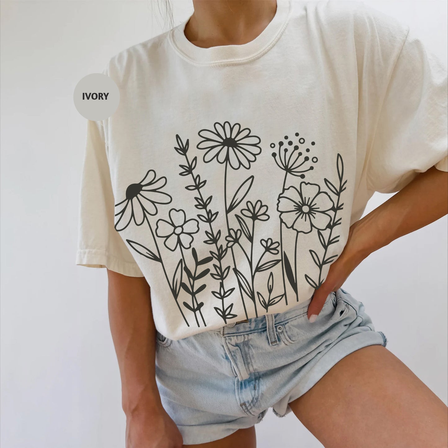 a woman wearing a t - shirt with flowers on it