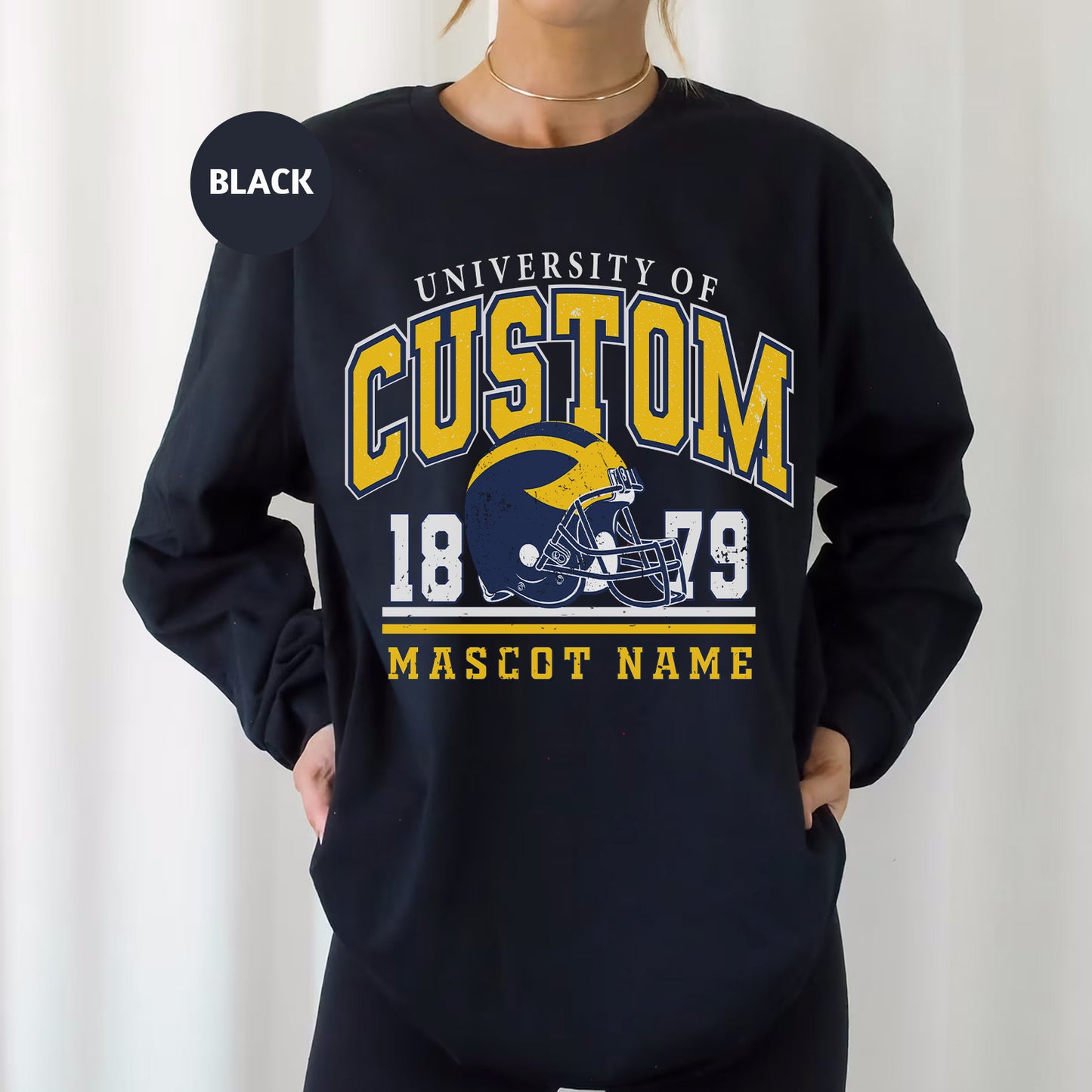 a woman wearing a black sweatshirt with a football helmet on it