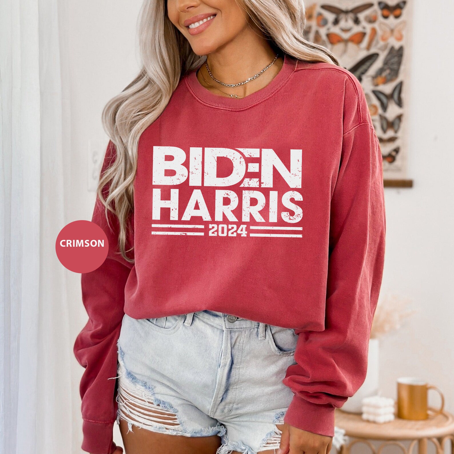 a woman wearing a red sweatshirt that says biden harris