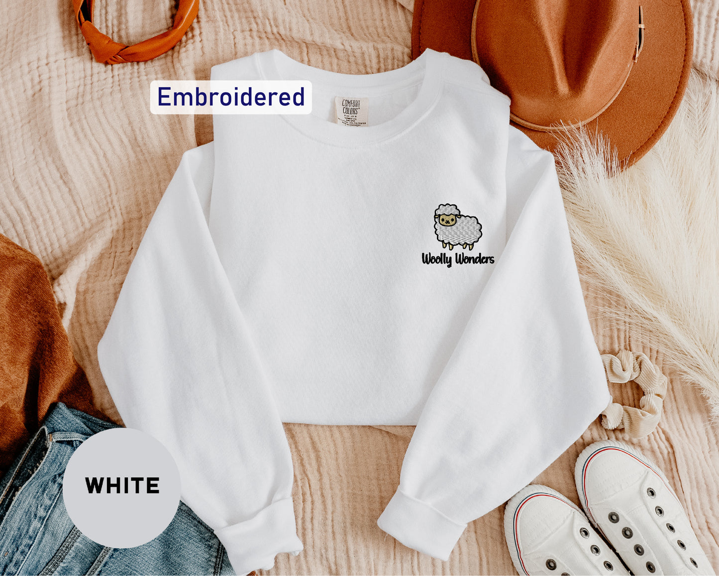 a white shirt with a sheep embroidered on it