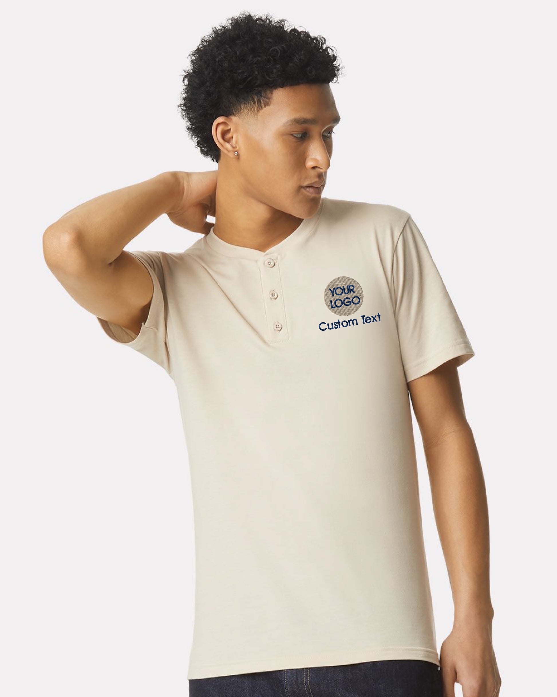 a man wearing a white shirt with a blue logo on it