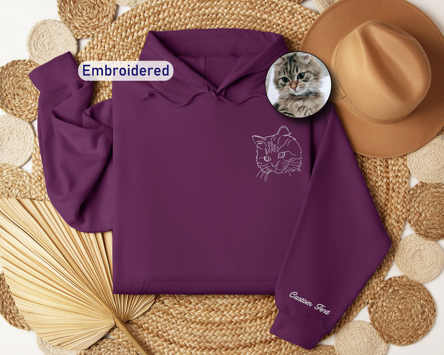 a purple hoodie with a picture of a cat on it