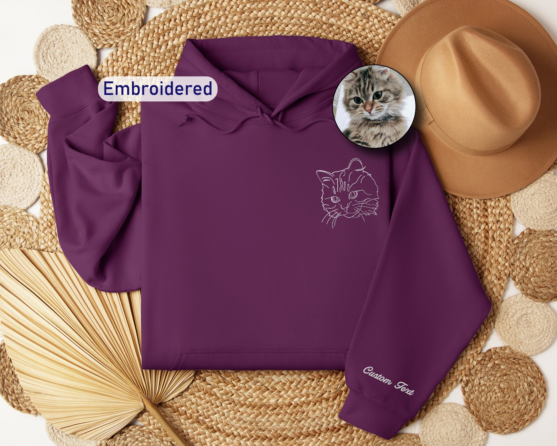 a purple hoodie with a picture of a cat on it