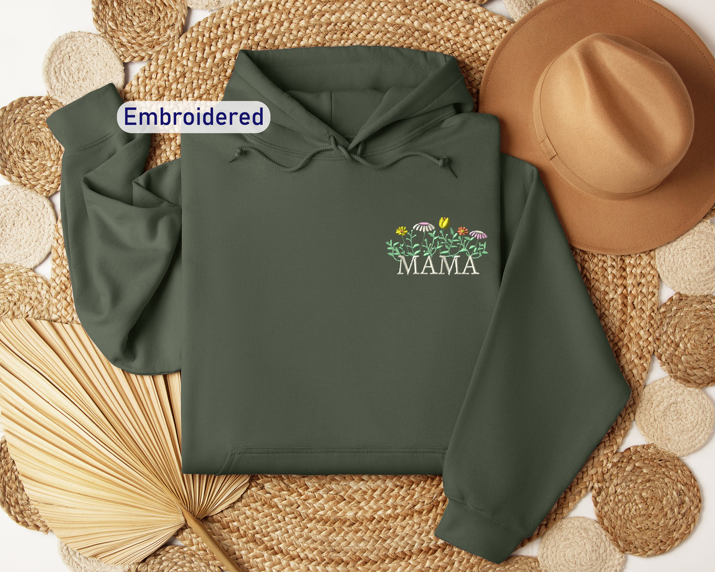 a green hoodie with the words embroidered on it