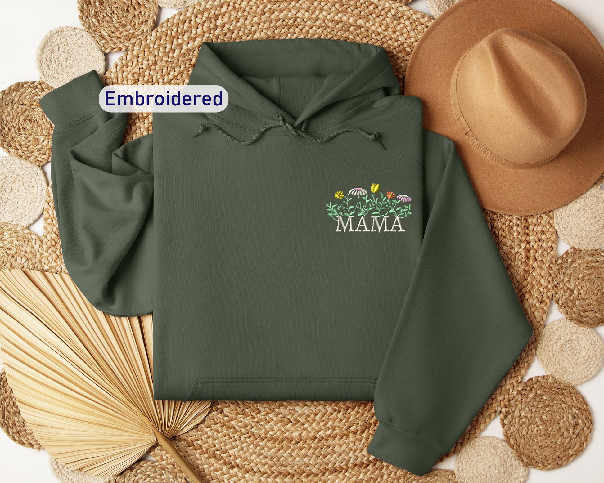 a green hoodie with the words embroidered on it