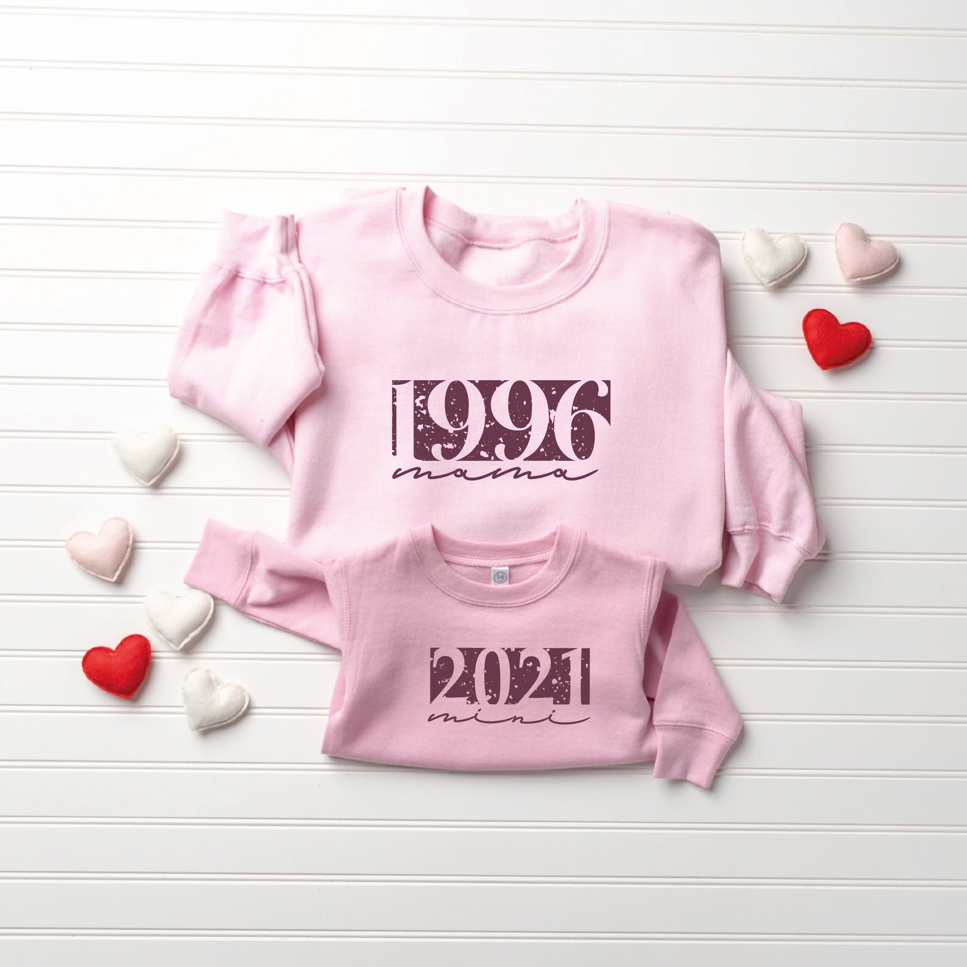 a couple of pink shirts sitting on top of a table