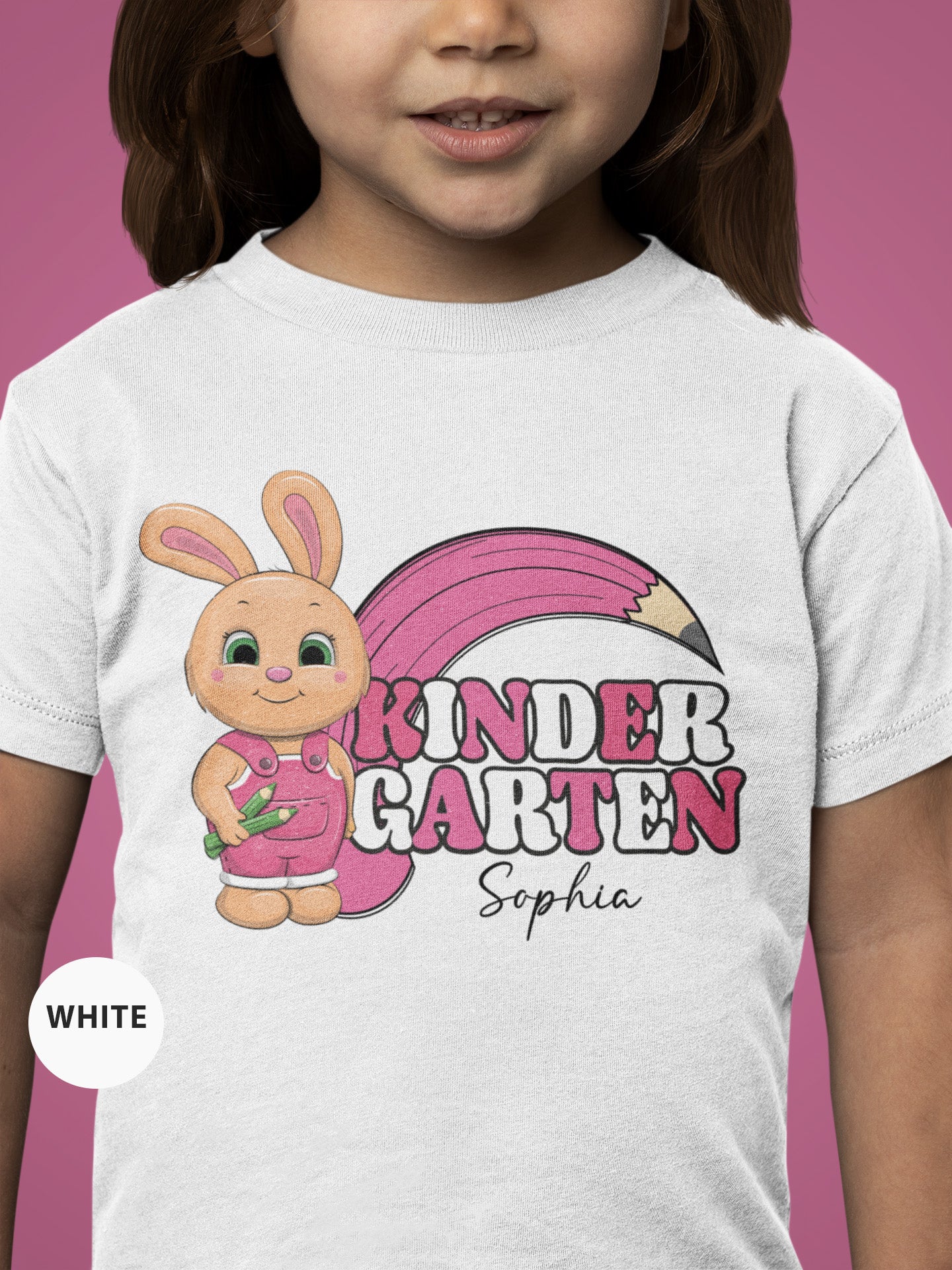 a little girl wearing a white shirt with a pink bunny on it