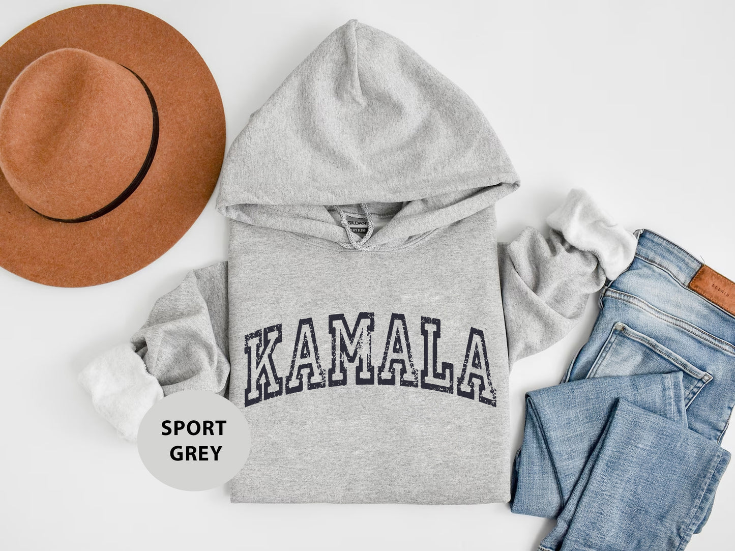 a hat, sweatshirt, jeans, and a pair of shoes are laid out on