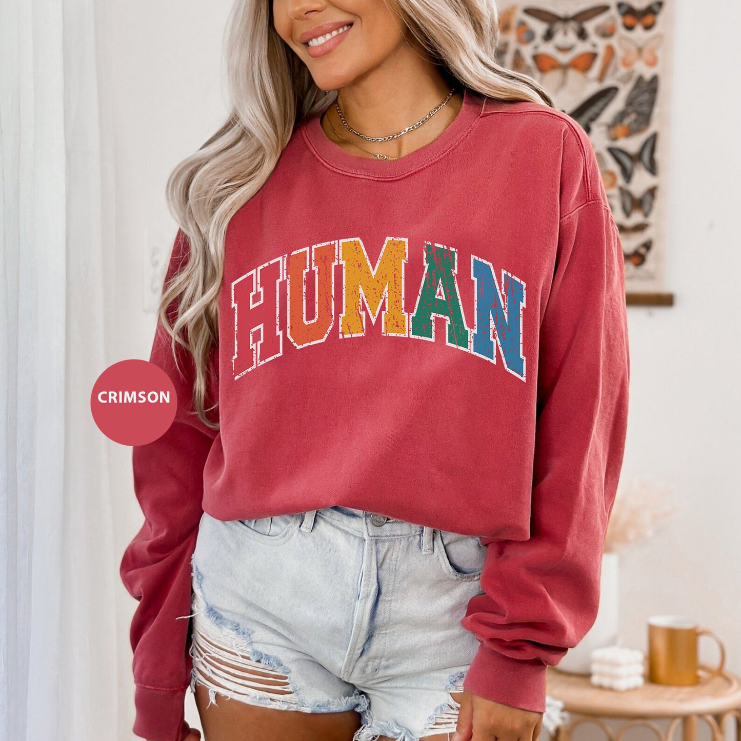 a woman wearing a red sweatshirt with the word human on it