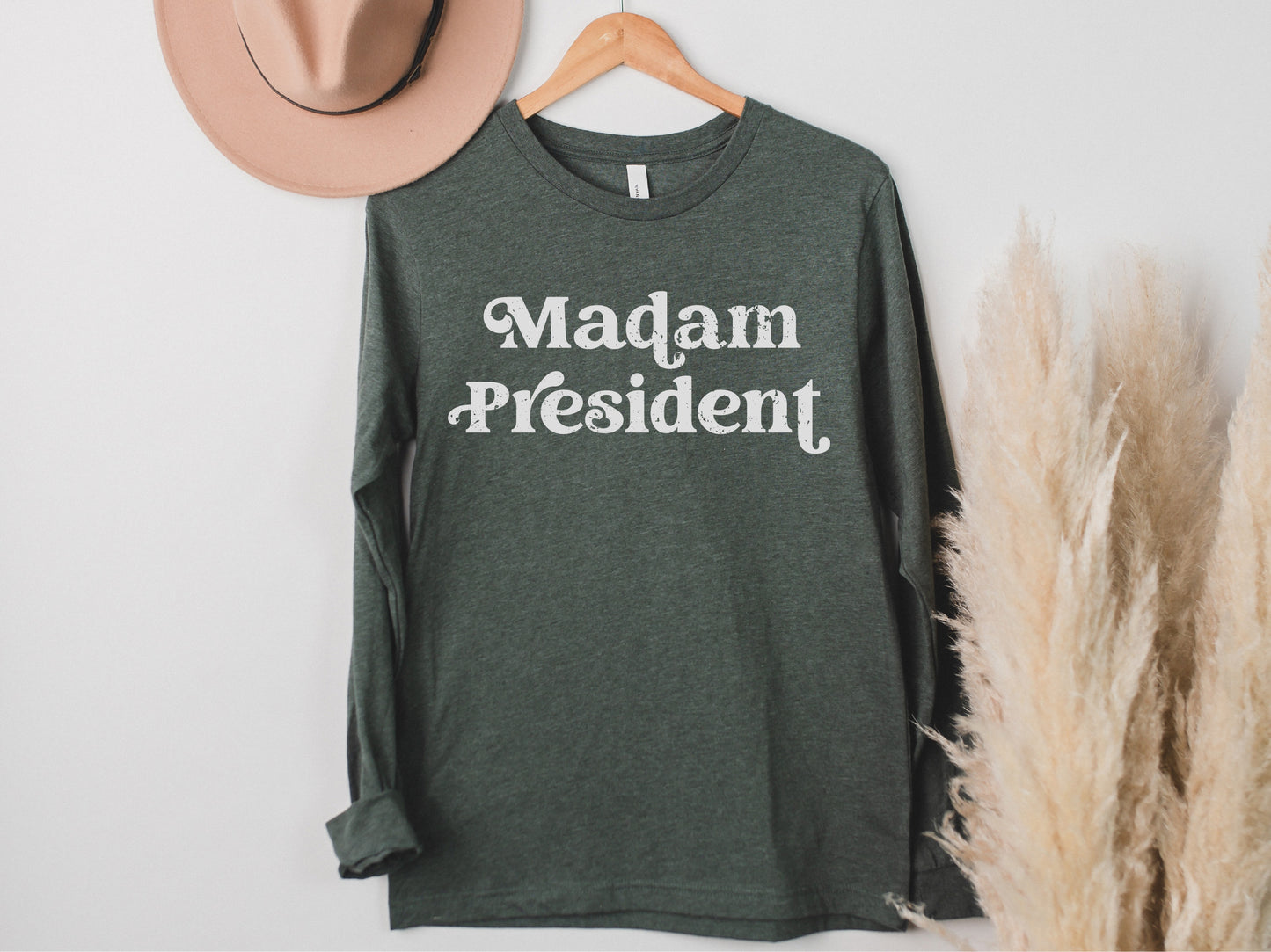 a t - shirt that says madam president hanging on a wall
