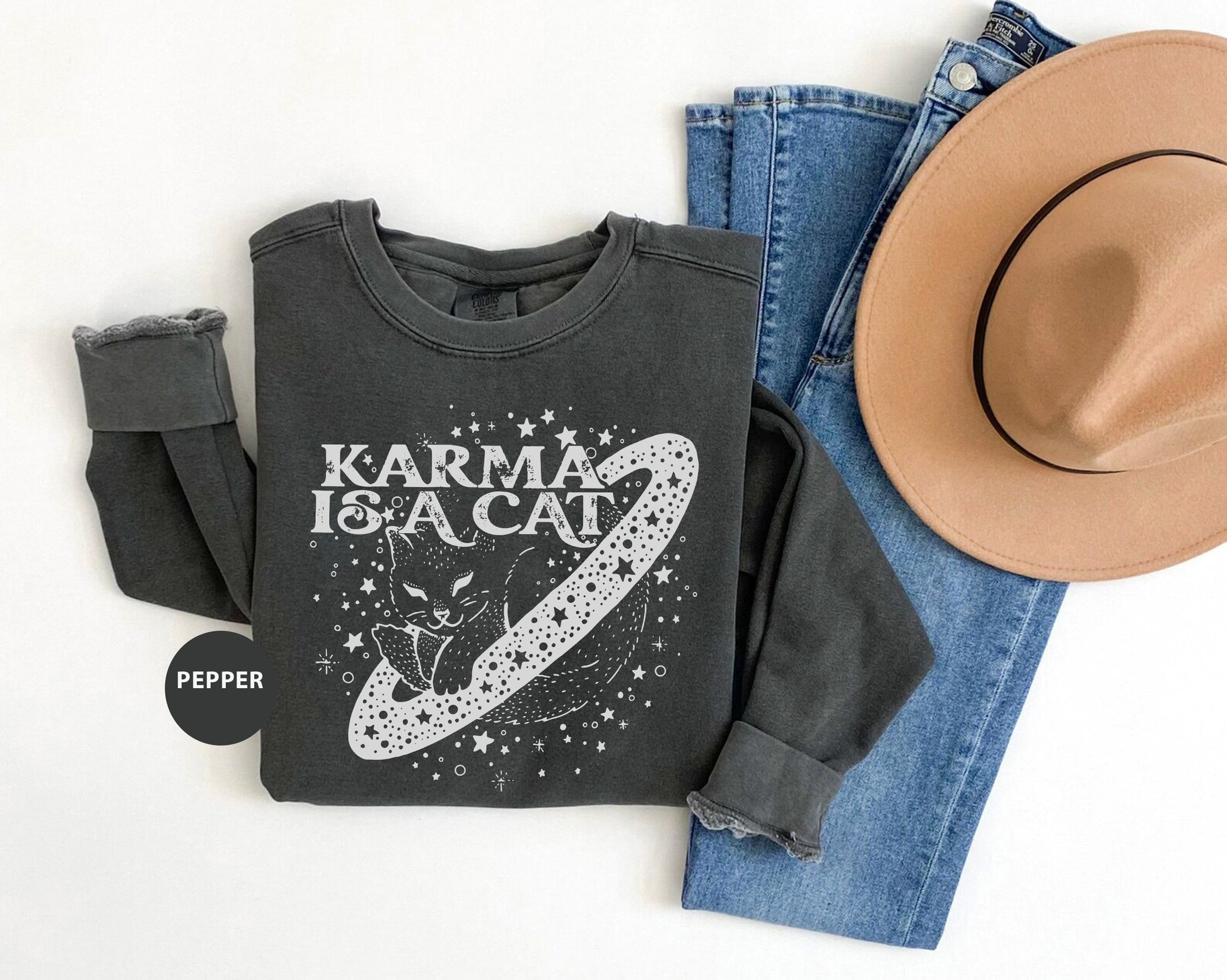 a hat, jeans, and a t - shirt on a white background