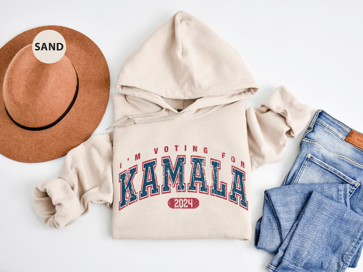 a hat, sweatshirt, jeans, and a pair of shoes are laid out on