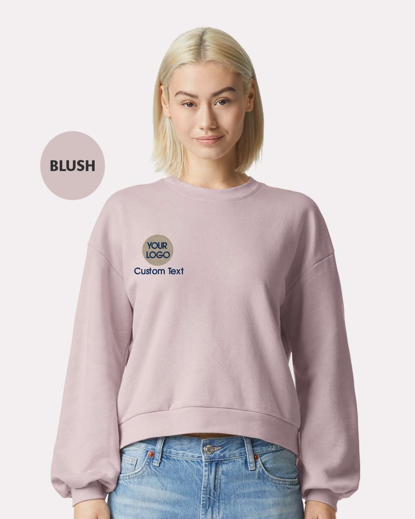 a woman wearing a pink sweatshirt and jeans