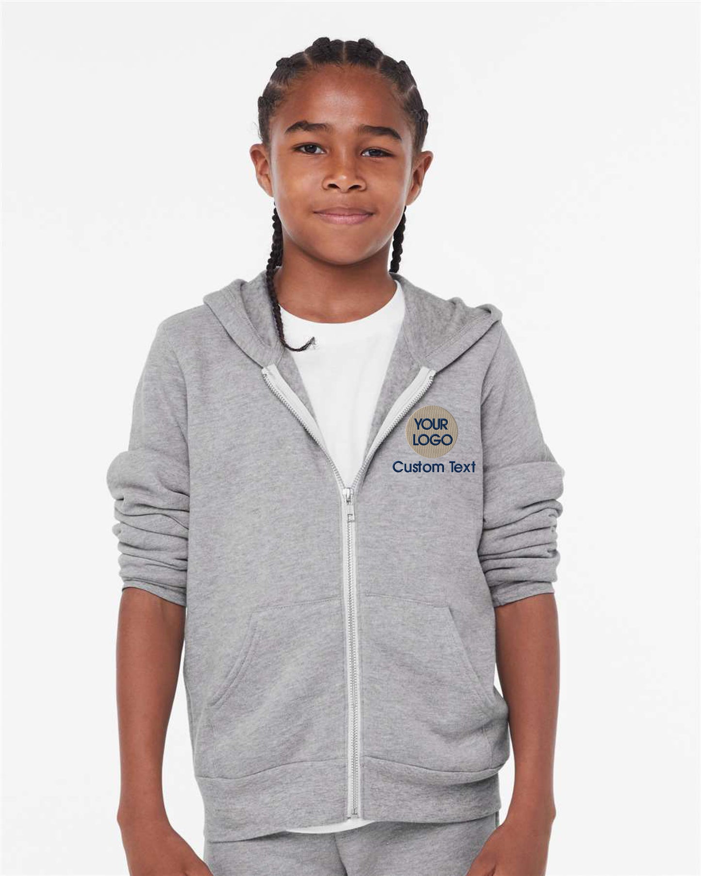 a young girl wearing a grey sweatshirt and shorts