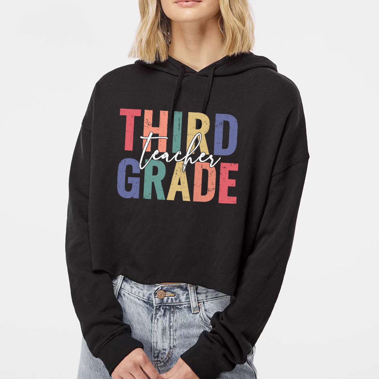 a woman wearing a black hoodie that says third grade