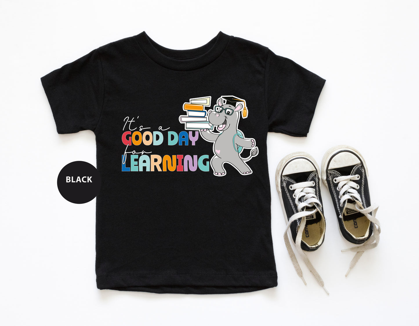 a pair of sneakers and a t - shirt with a cartoon dog on it