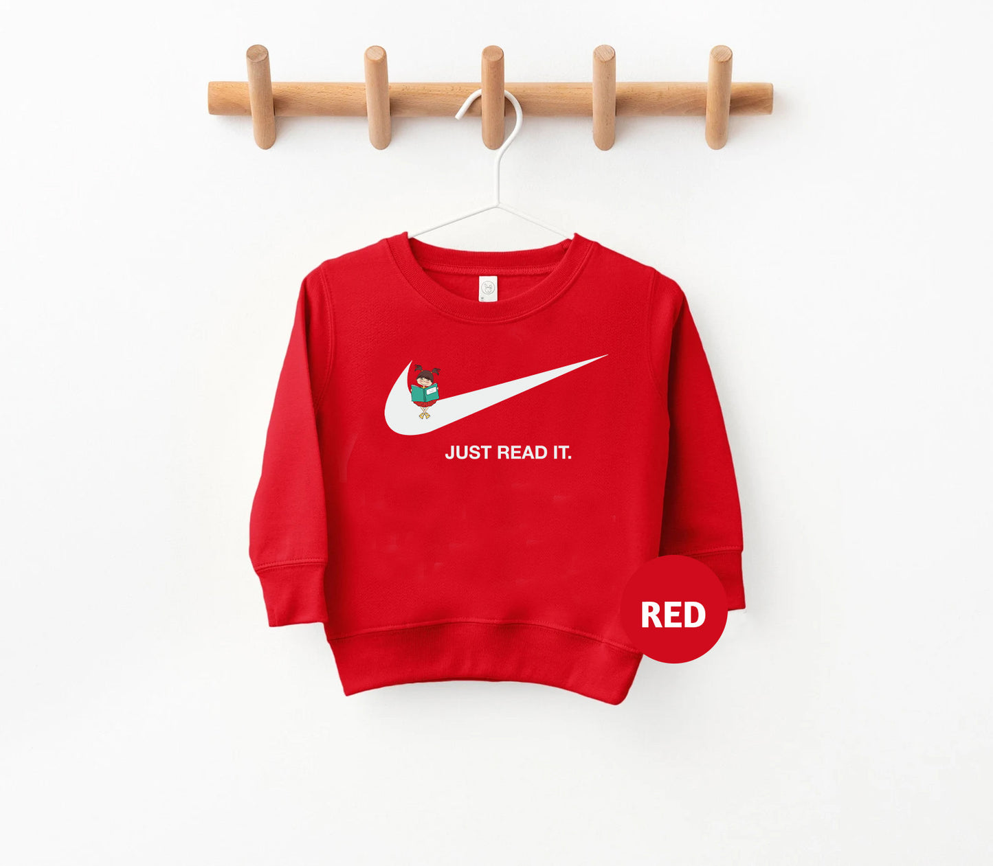 a red sweatshirt hanging on a wooden hanger