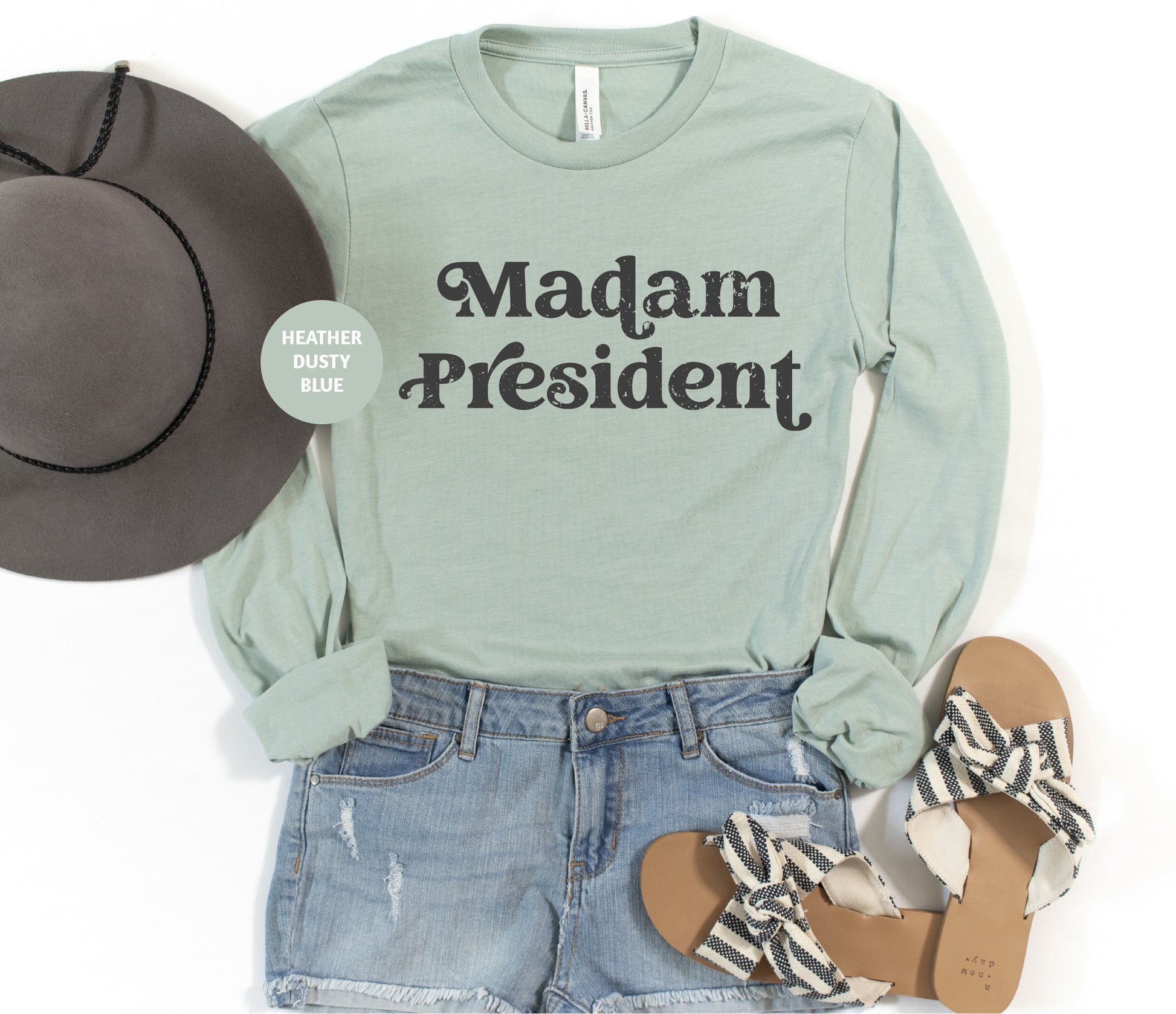 a woman's outfit with a hat, sandals, and a t - shirt