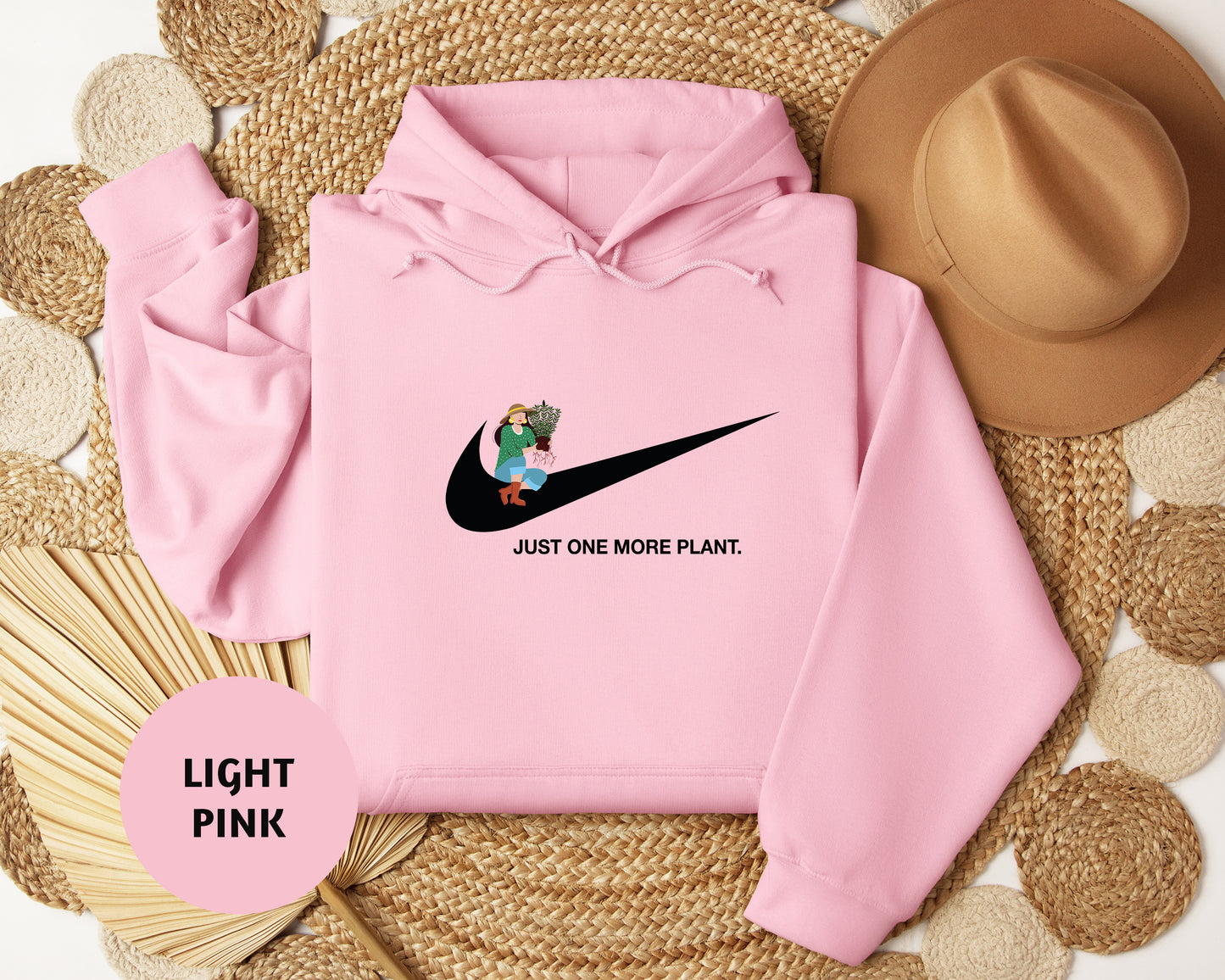 a pink hoodie with a black nike logo on it