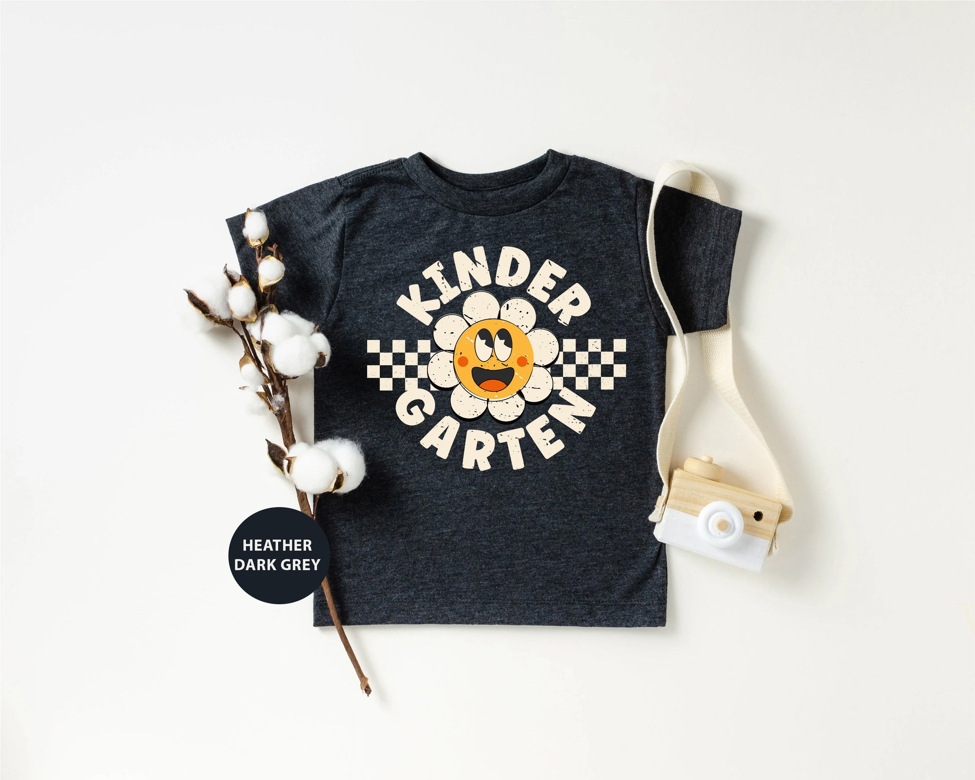 a kid's t - shirt with a camera next to it