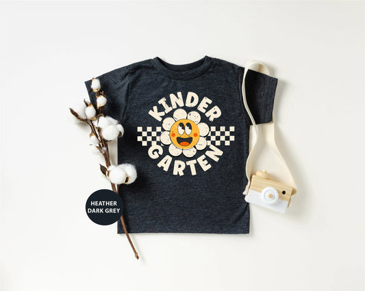 a kid's t - shirt with a camera next to it