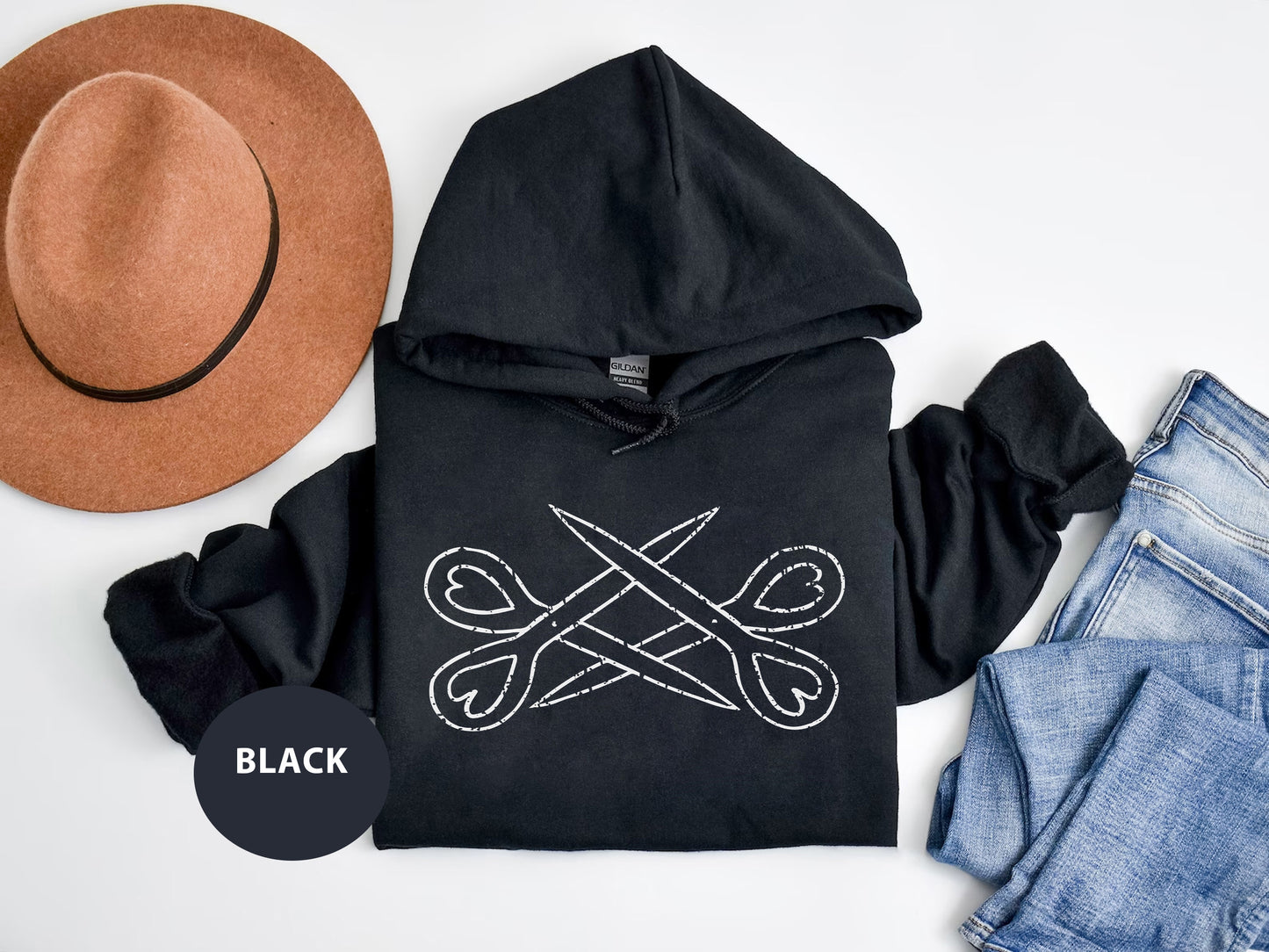 a black hoodie with a pair of scissors on it