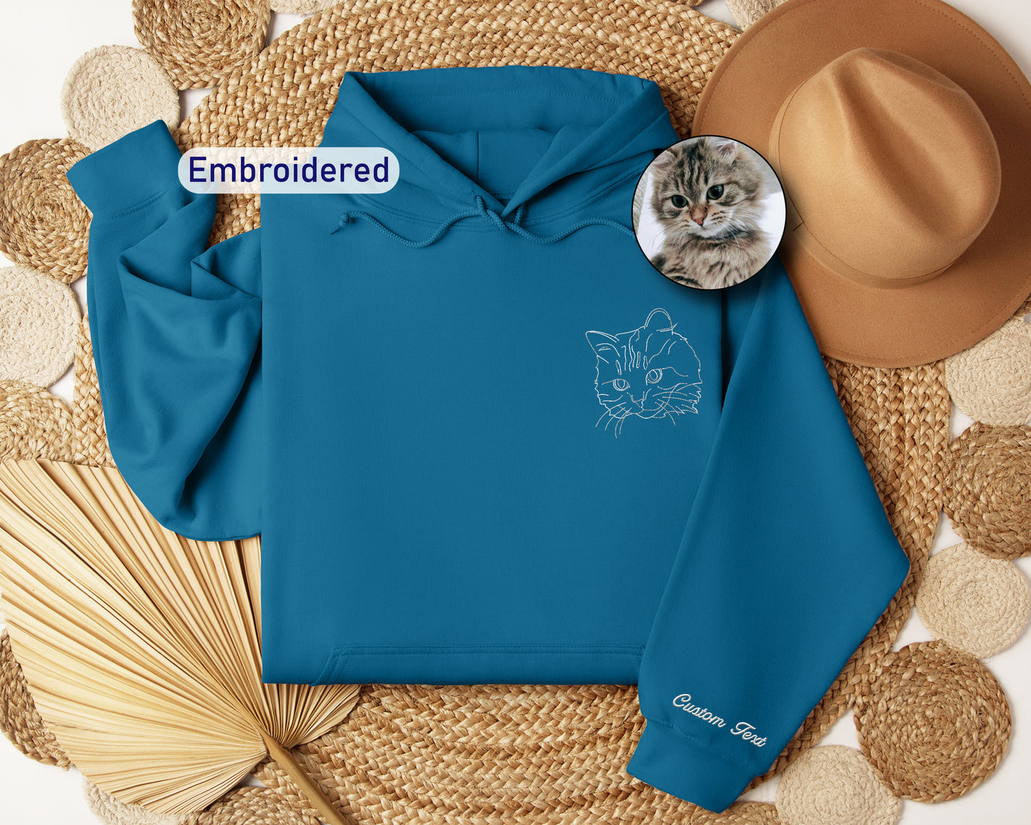a blue hoodie with a picture of a cat on it