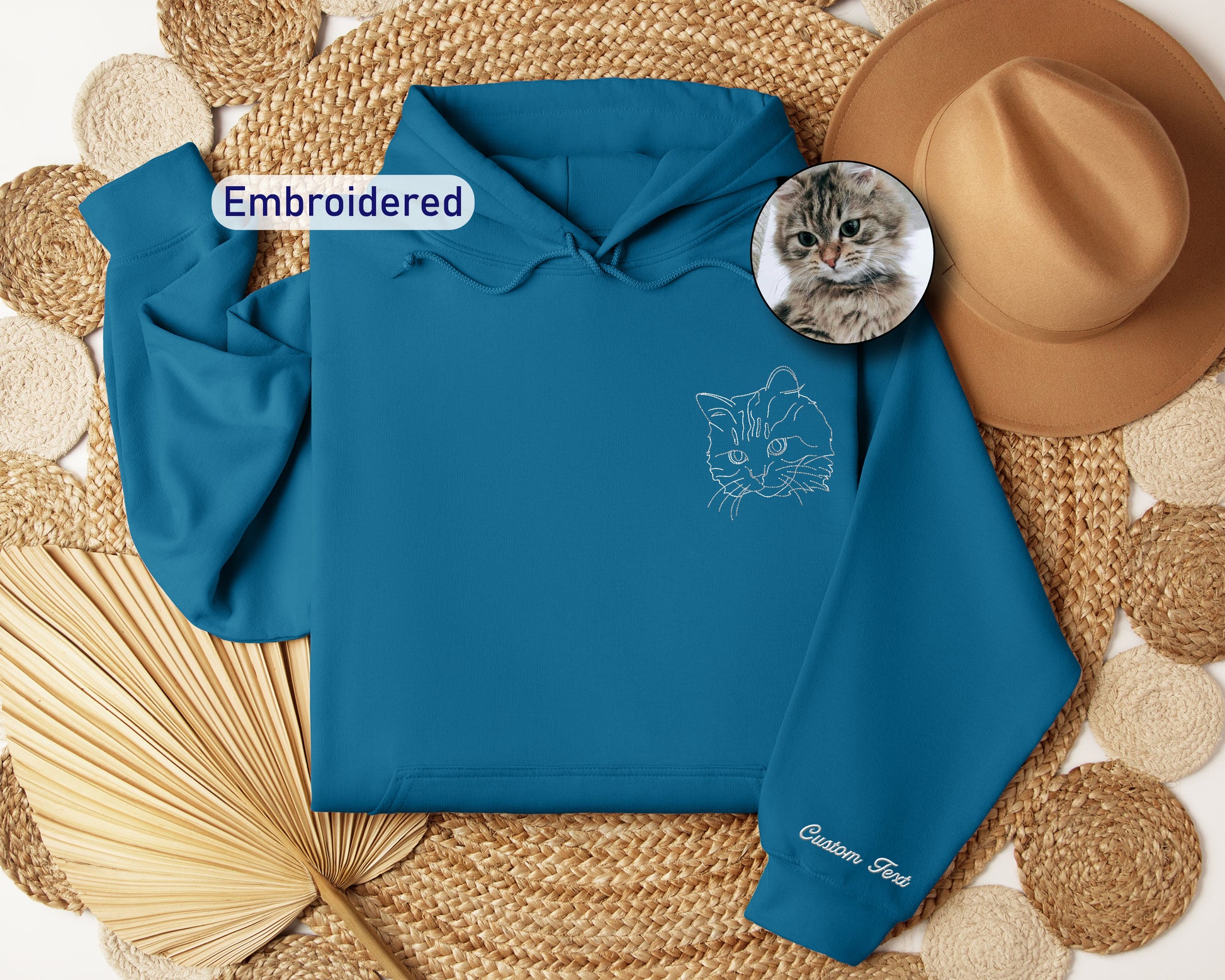 a blue hoodie with a picture of a cat on it