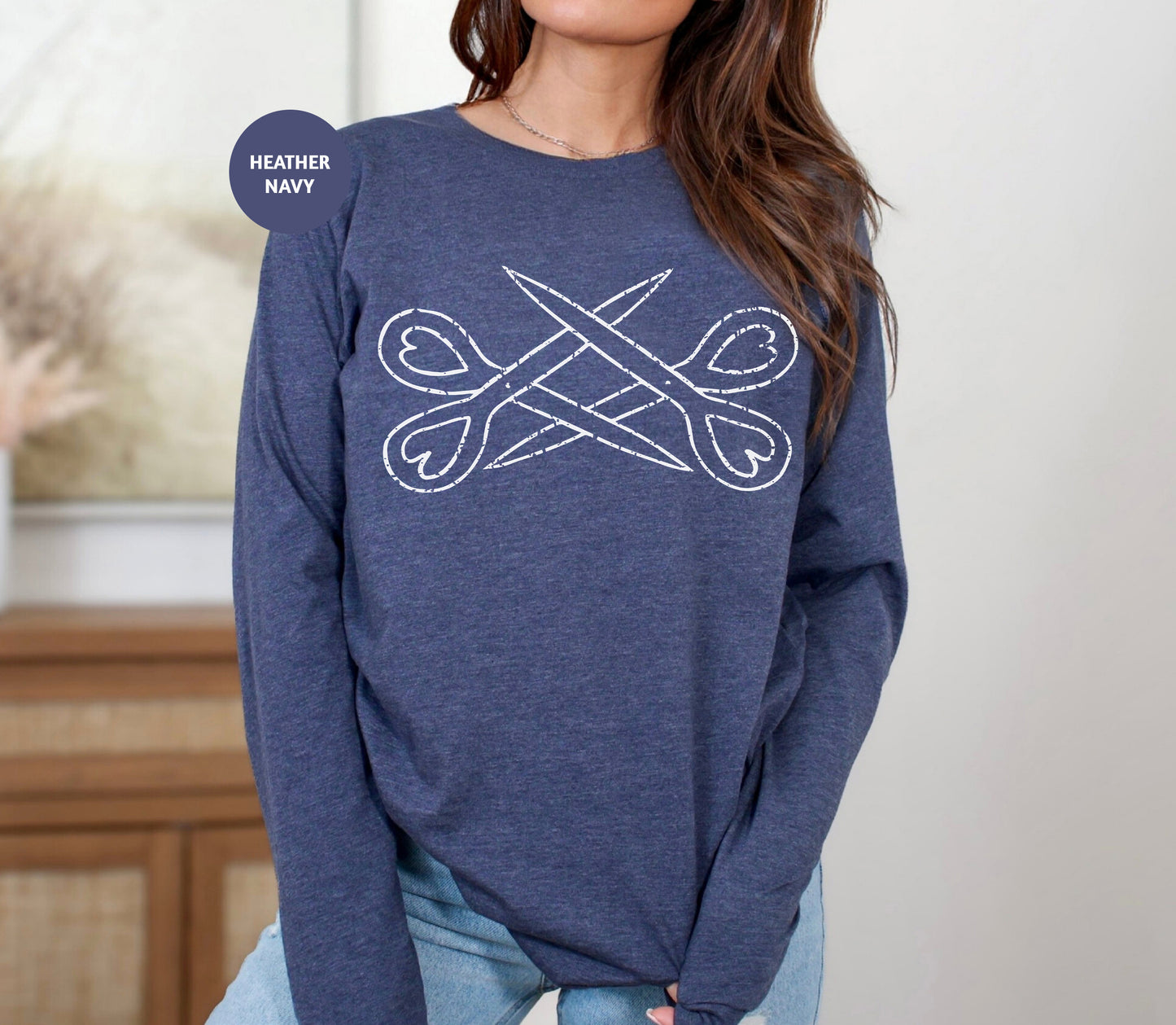 a woman wearing a blue sweater with scissors on it