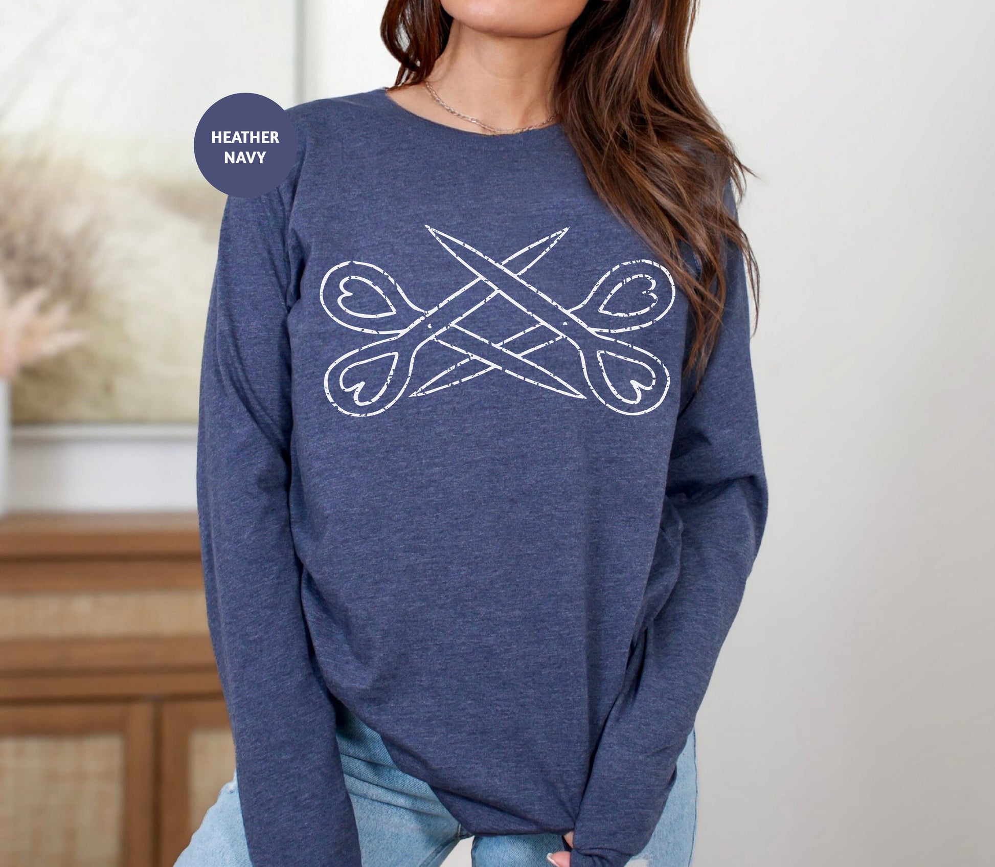 a woman wearing a blue sweater with scissors on it