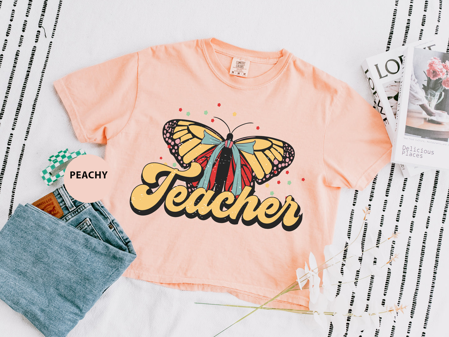a t - shirt that says teacher with a butterfly on it
