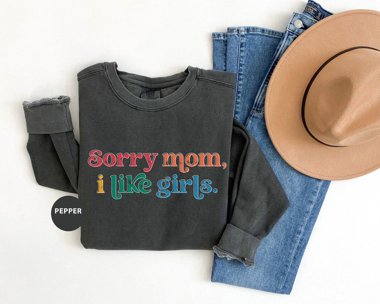 a black shirt that says sorry mom, i like girls next to a cowboy hat