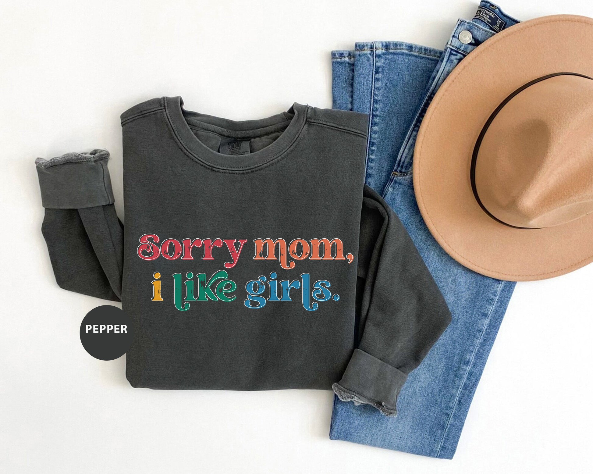 a black shirt that says sorry mom, i like girls next to a cowboy hat