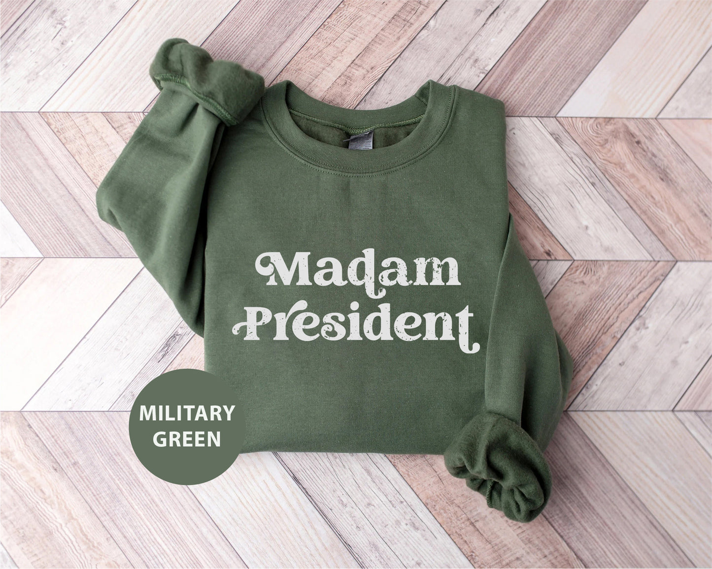 a green sweatshirt with the words madam president printed on it