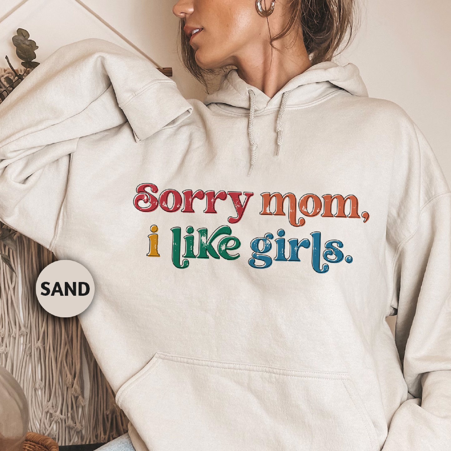 a woman wearing a white hoodie that says sorry mom, i like girls
