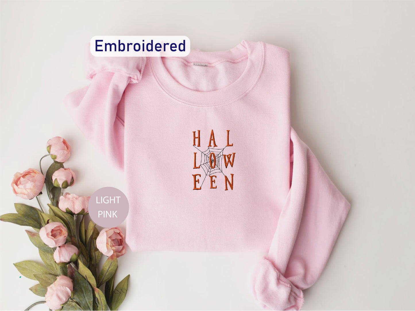 a pink sweater with the words hallow een printed on it