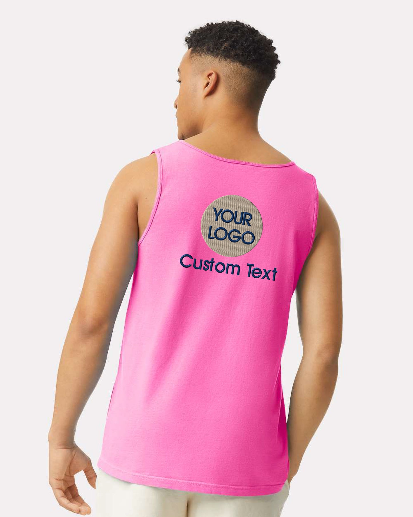 a man wearing a pink tank top with a custom text