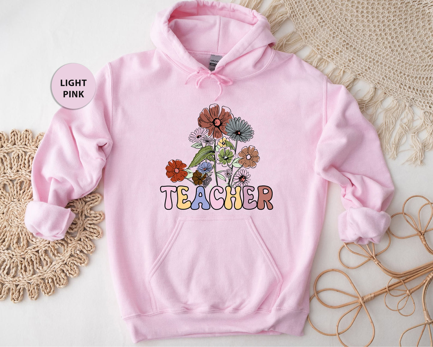 a pink hoodie with the words teacher printed on it