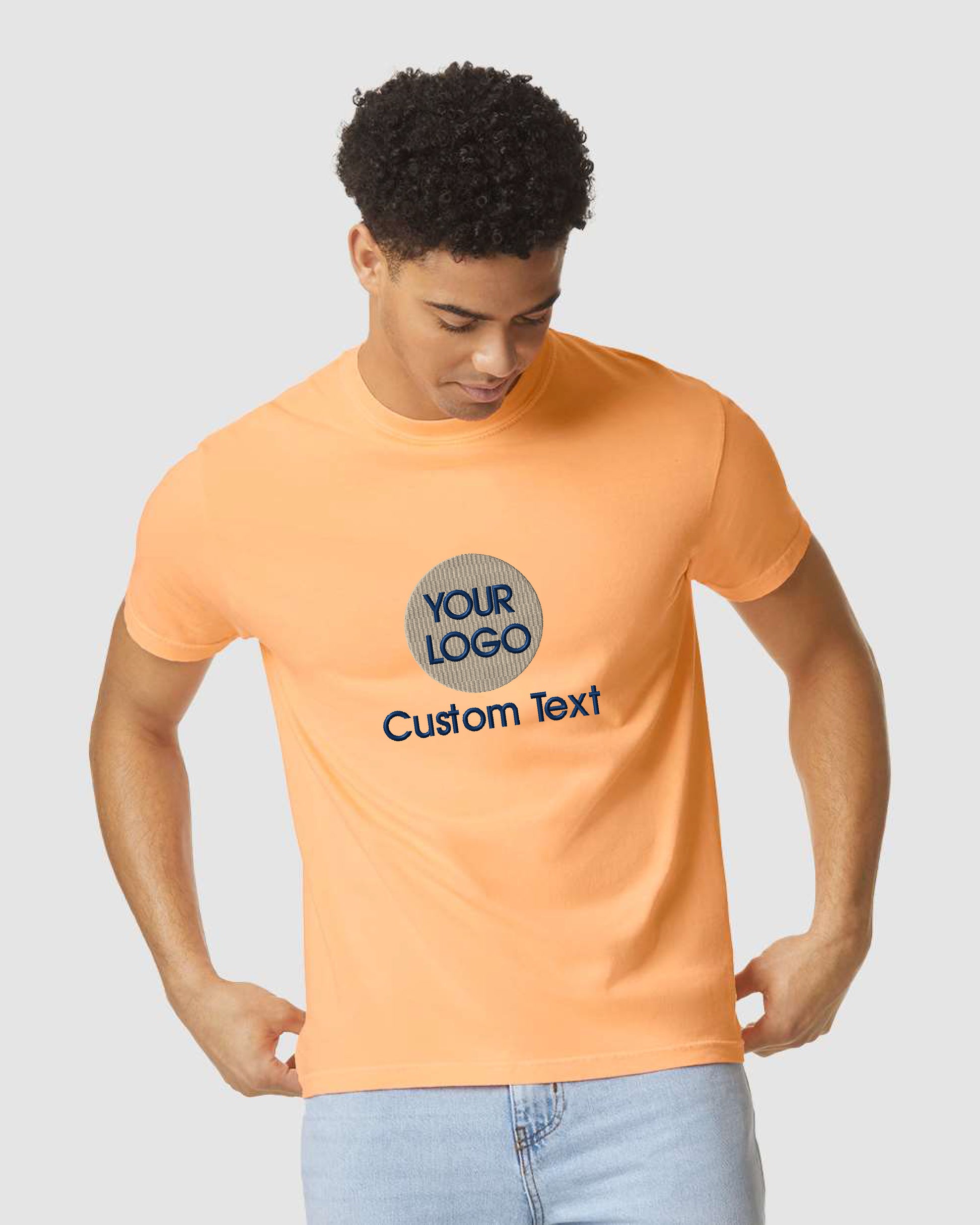 a man wearing an orange t - shirt and jeans