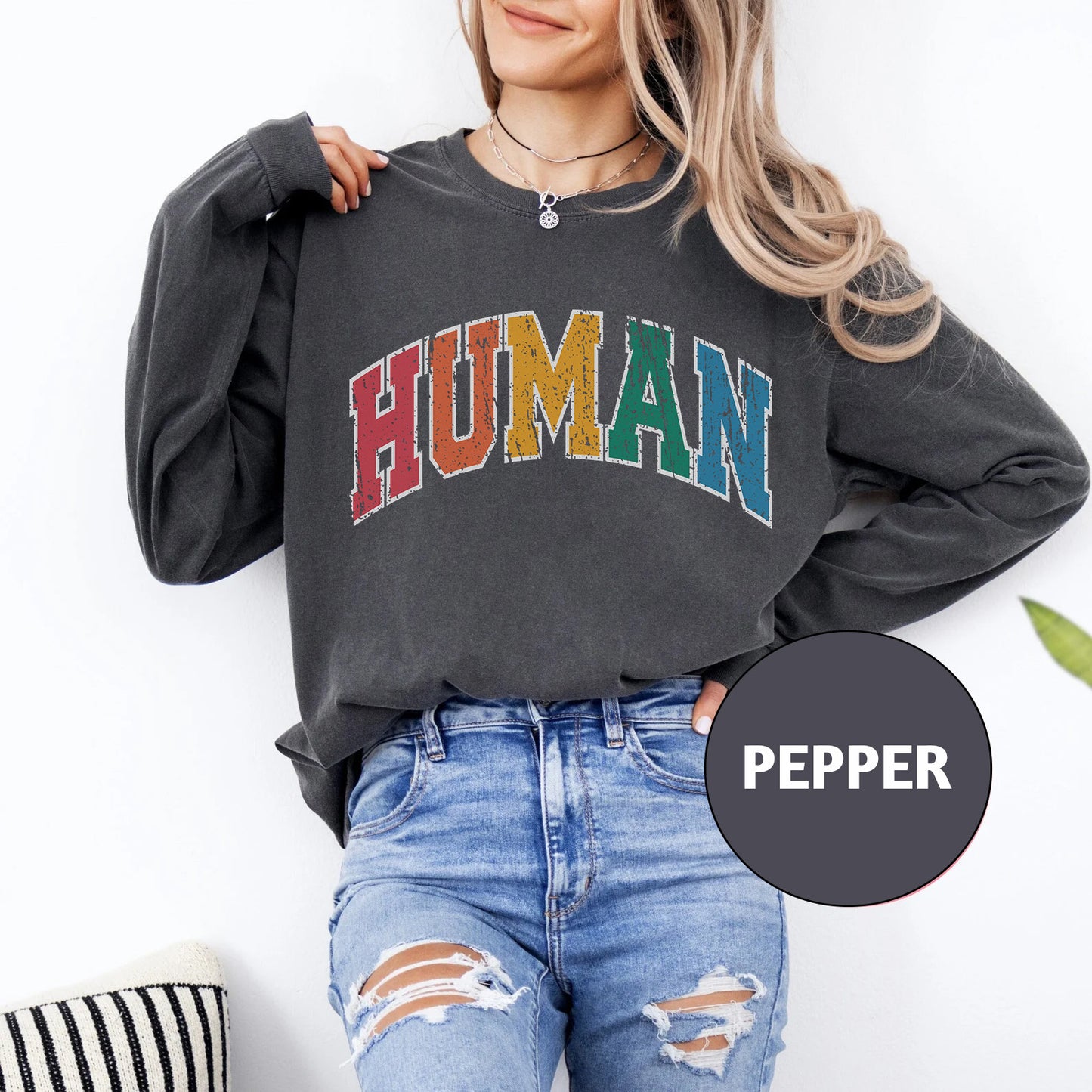 a woman wearing a sweatshirt with the word human on it