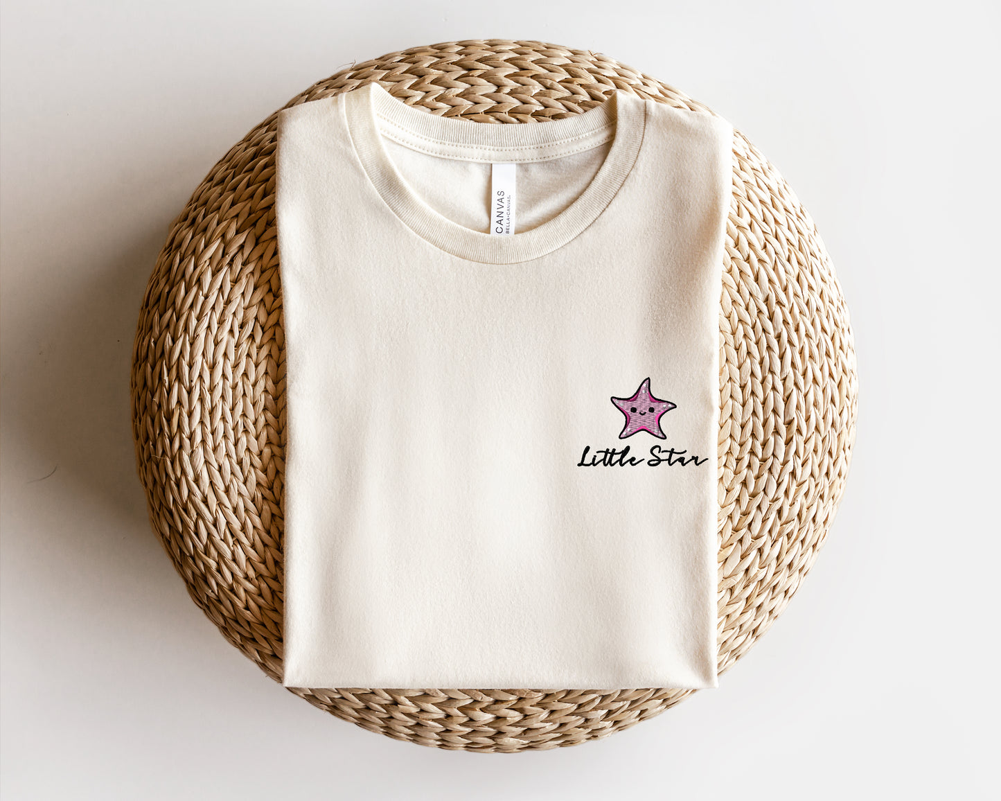 a white t - shirt with a pink star on it