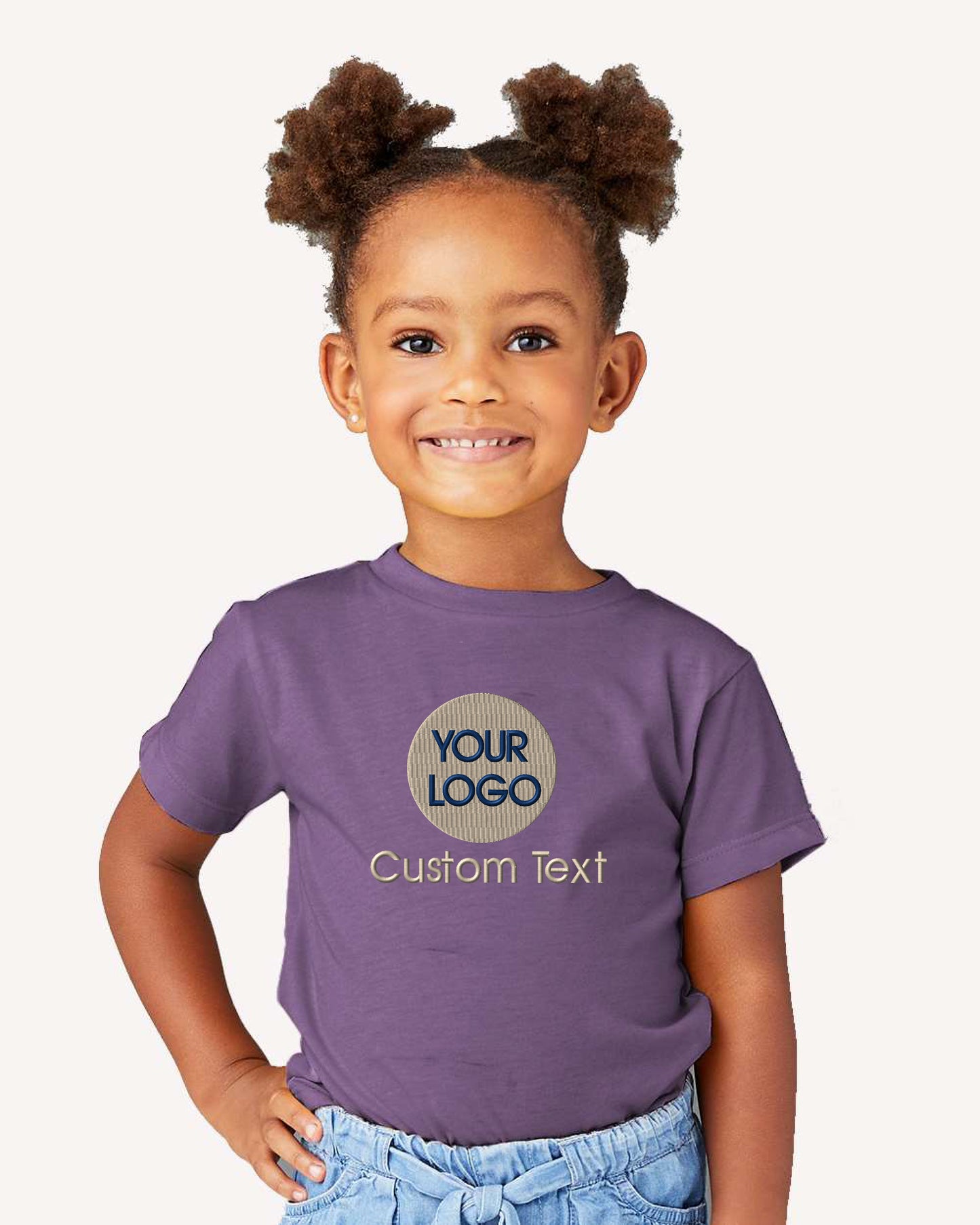 a little girl wearing a purple t - shirt with a logo on it