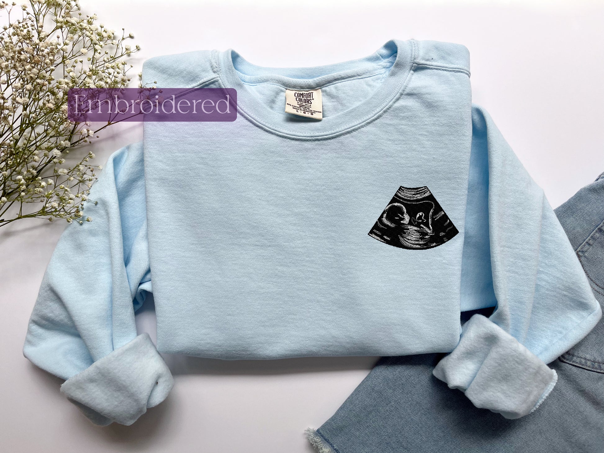 a blue shirt with a black cat on it