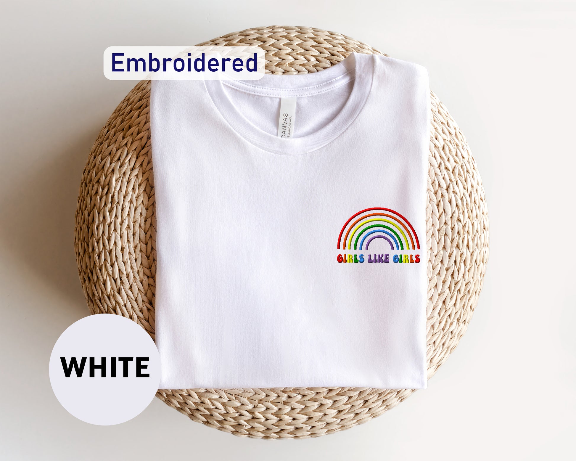 a white t - shirt with a rainbow embroidered on it