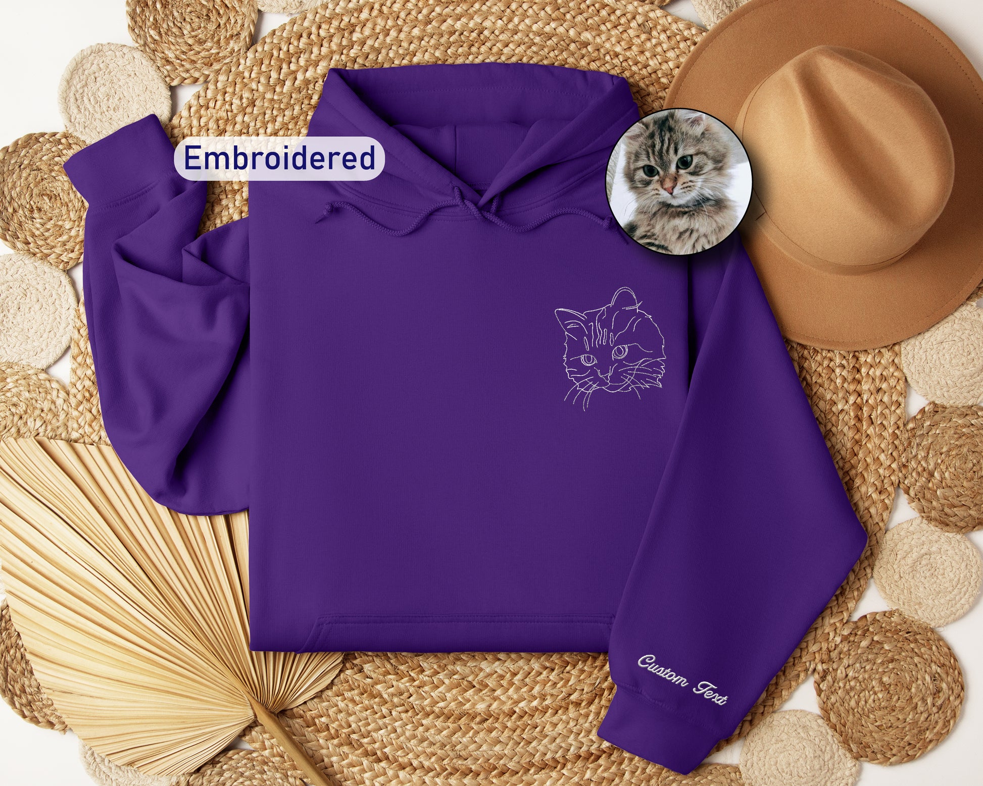 a purple hoodie with a picture of a cat on it